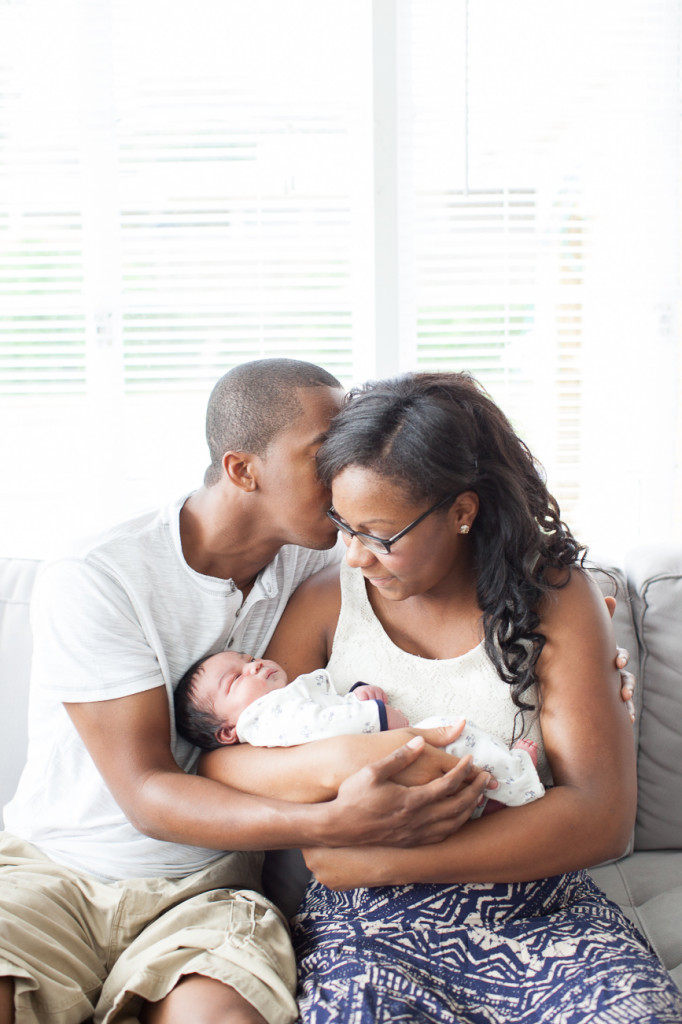 Orlando Lifestyle Newborn Photography Dad kissing mom holding newborn