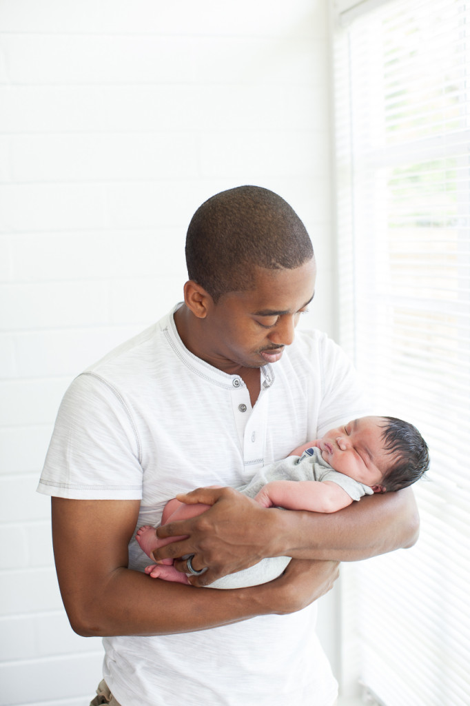 Orlando Lifestyle Newborn Photography New dad holds newborn