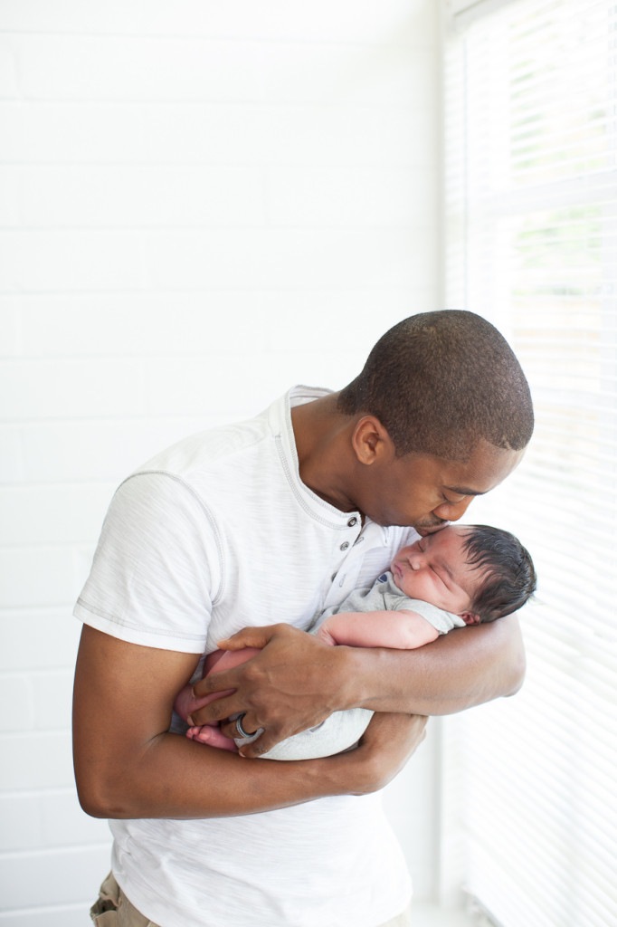 Orlando Lifestyle Newborn Photography Dad kissing newborn baby